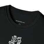 A close up of a black t-shirt collar with the website address "periodicstyle.com" printed inside the collar and the words "100% Cotton" printed below