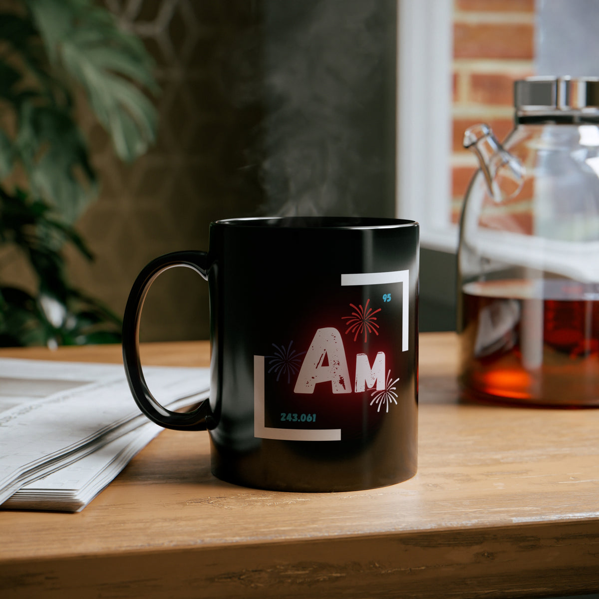 Front of black coffee mug with atomic symbol for Americium.Includes atomic mass and atomic number.Context photo of mug on a desk.